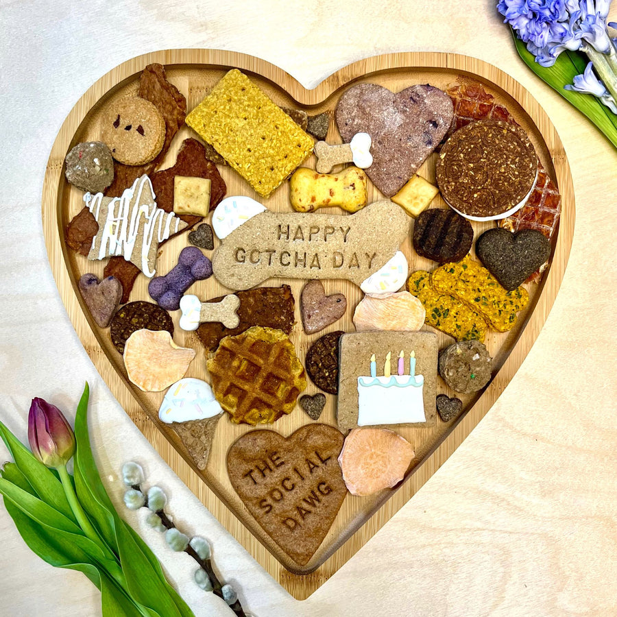 Heart-shaped barkuterie board with with treats. 